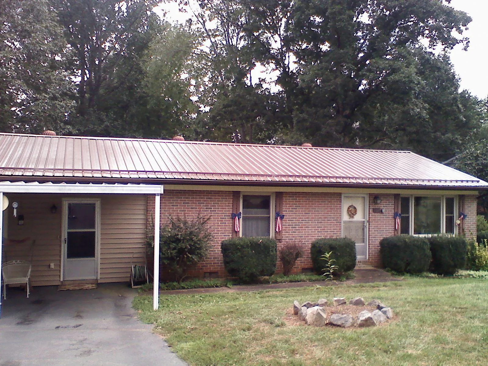 Bronze metal roof and carport on a brick ranch home — Roof Repair work by our crew in Richboro